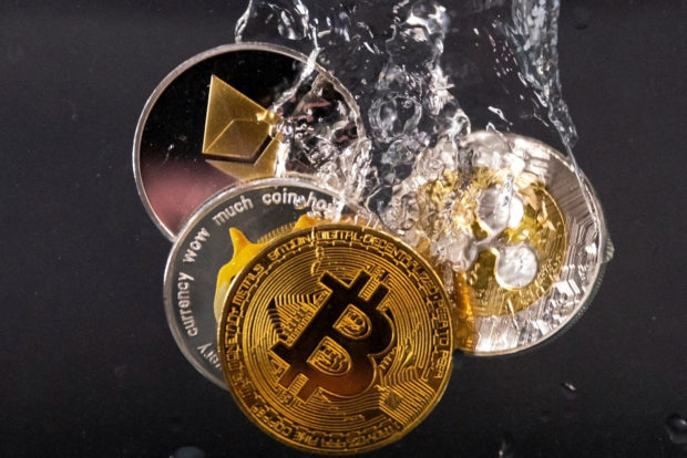 Souvenir tokens representing Bitcoin, Ethereum, Dogecoin and Ripple