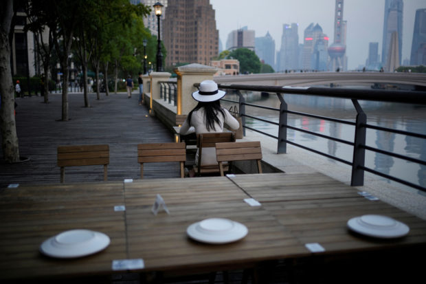 Woman sitting in a restaurant on a river bank