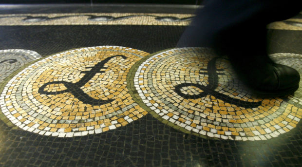 Person walking on mosaic of pound sterling