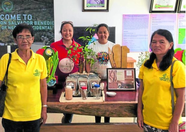 Plantsville Health founder November Canieso-Yeo (in red) with Integrated Social Forest Farmers Association’s leaders