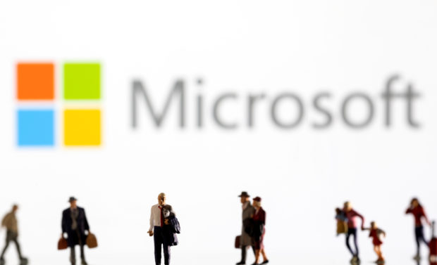 small figurines in front of Microsoft logo