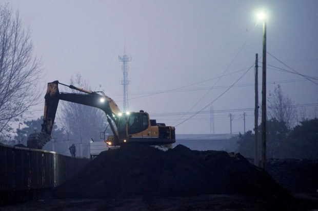 Excavator loads coal to a train in China