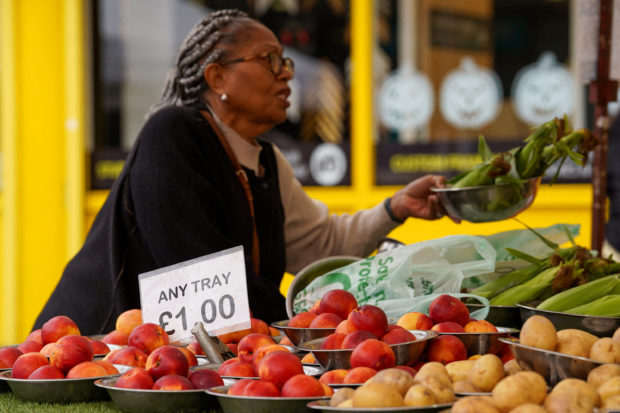Woman shops for food items in London market