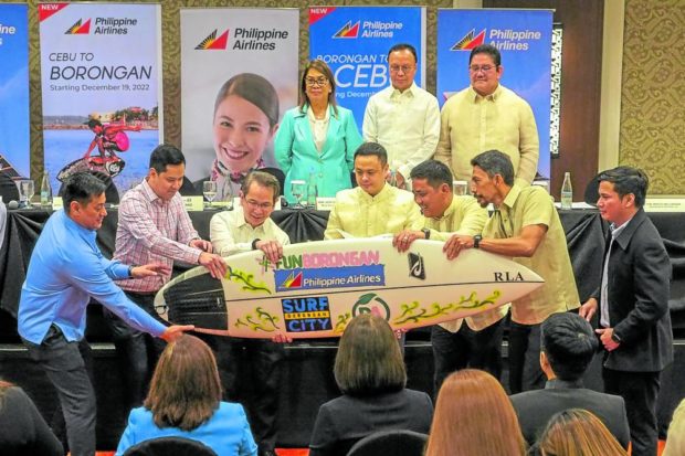 Borongan City officials present a surfboard created by a local Boronganon surfer and hand painted by artist AG Sano to executives of flag carrier Philippine Airlines.