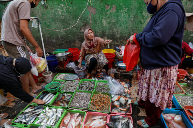A vendor serving her customers in Jakarta
