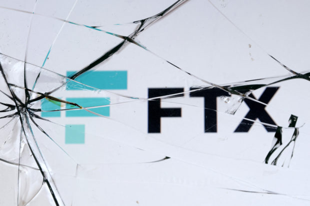 FTX logo seen through broken glass