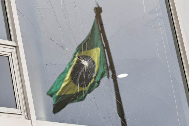 Brazil flag reflected on broken window