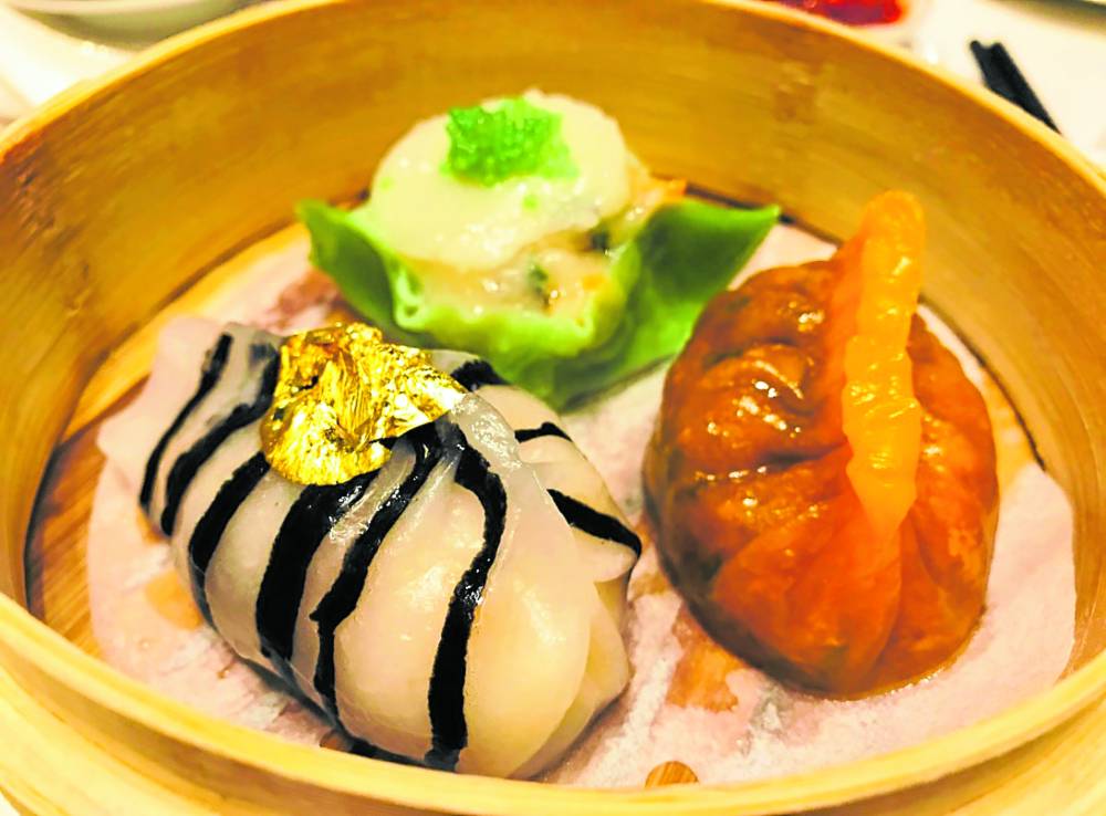 Eat as many meatballs as you can;  (left) Gold-leafed dumplings for wealth at Crystal Dragon