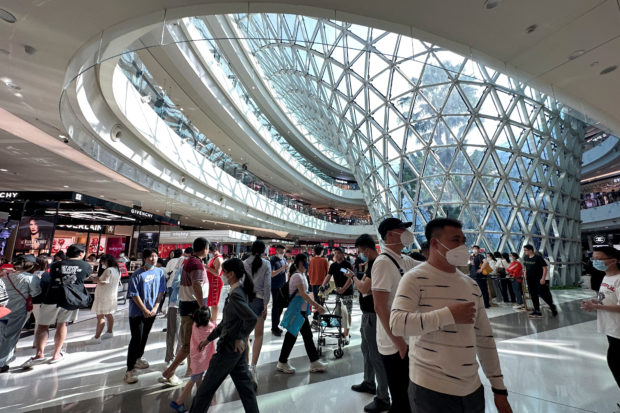 People in a shopping mall in Hainan, China