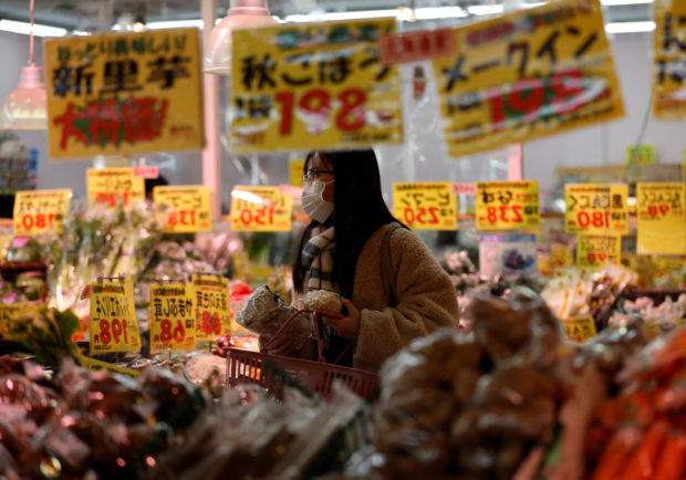 Shopper checks food items at a supermarket in Tokyo