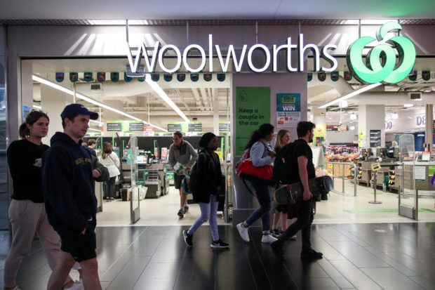 People walk past a Wooworths supermarket in Sydney