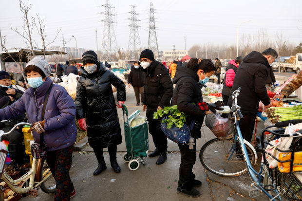 People shopping at an outdoor market in Beijing
