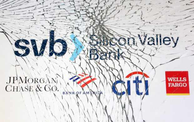 Logos of SVB and major banks seen through a broken glass