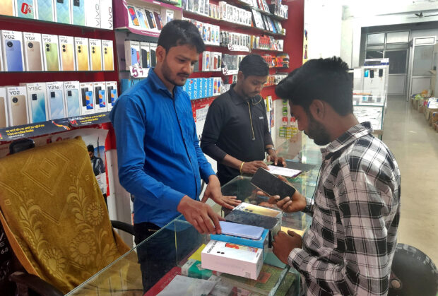 Customer checks a Samsung phone in a store in Lucknow, India