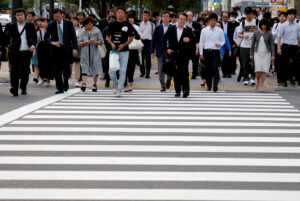 Pedestrians make their way in a business district in Tokyo