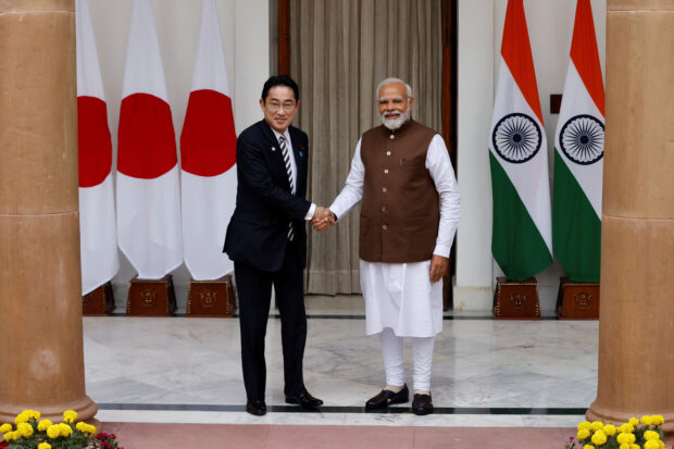 Japan Prime Minister Fumio Kishida shakes hands with his Indian counterpart Narendra Modi 