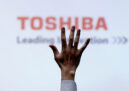 A reporter raises his hand for a question in a Toshiba press briefing