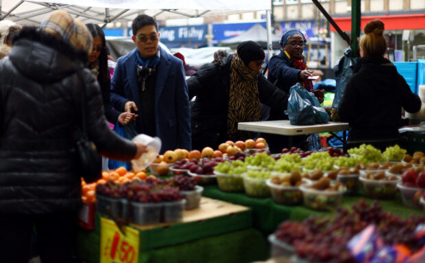 People shop for fruits and vegetables at Lewisham Market 8 in south east London