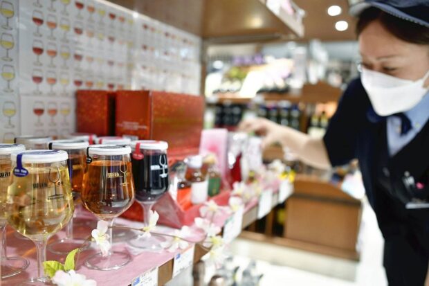 Wine in plastic cups are seen at the Daimaru Tokyo department store 
