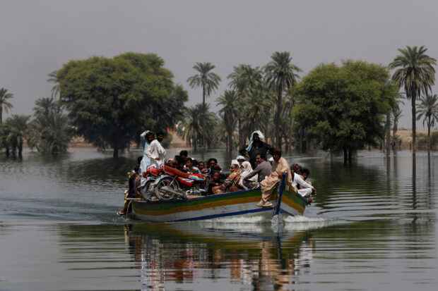 Flood victims in a boat during monsoon season in Pakistan