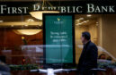 A person walks past a First Republic Bank branch in Midtown Manhattan