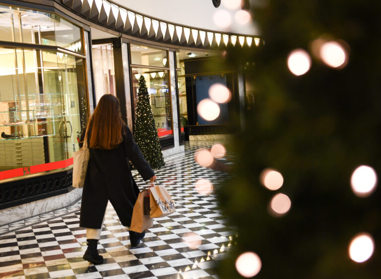 A woman walks with shopping bags through a mall in Berlin