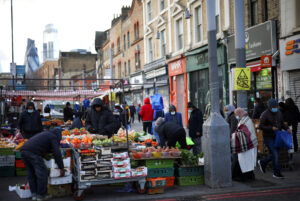 People shop at a market in east London
