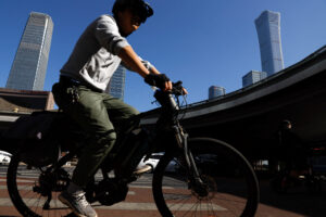 Man rides a bicycle at Beijing central business district