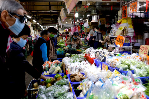 People shop in a market in Taipei