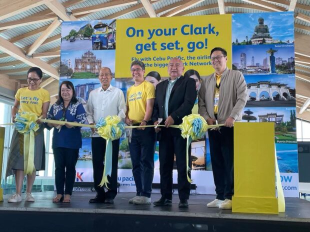 Cebu Pacific revives its hub at the Clark International Airport inside the Clark Freeport in Pampanga. (From right) Noel Manankil, president and CEO of Luzon International Premiere Airport Development; Tourism Undersecretary Ferdinand Jumapao; Xander Lao, Cebu Pacific president and chief commercial officer; BCDA chair Delfin Lorenzana and president Aileen Zosa; and Candice Iyog, Cebu Pacific vice president for marketing and customer experience lead the hub's relaunch on Friday, April 21, 2023 and saw off four inaugural flights.