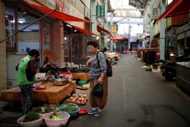 A woman shops at a traditional market in South Korea