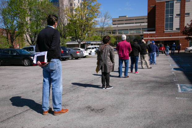 People wait in line outside a career center in Kentucky