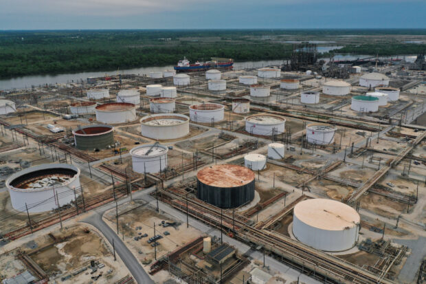 Oil tanker and storage tanks at Exxon refinery