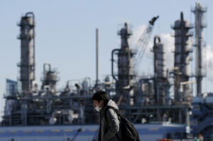 worker walks near a factory in Kawasaki, Japan