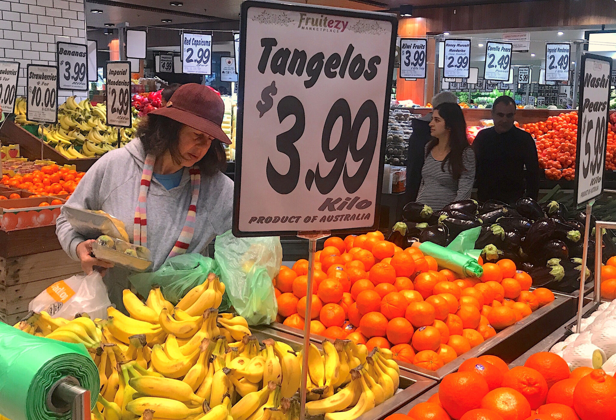 Shoppers look at fruits and vegetables at store in Sydney