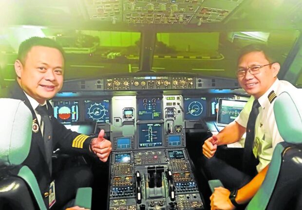 Stanley Ng (left), PAL president and chief operatingofficer, piloted an aircraft to Perth, the airline’s newest long-haul route, assisted by officer Jose Joel Mira in this March 27, 2023 photo. 