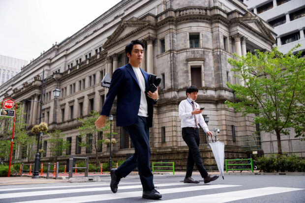 People walk in front of Bank of Japan building in Tokyo