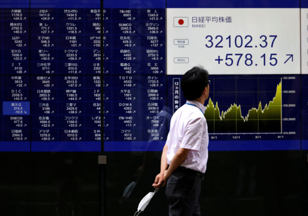 A man looks at an electric monitor displaying a stock quotation in Tokyo