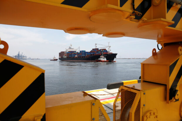 Cargo ship towed in by tugboats in Jakarta