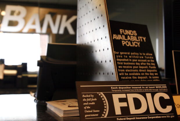 Signs of banking policies seen on the counter of a bank in Colorado