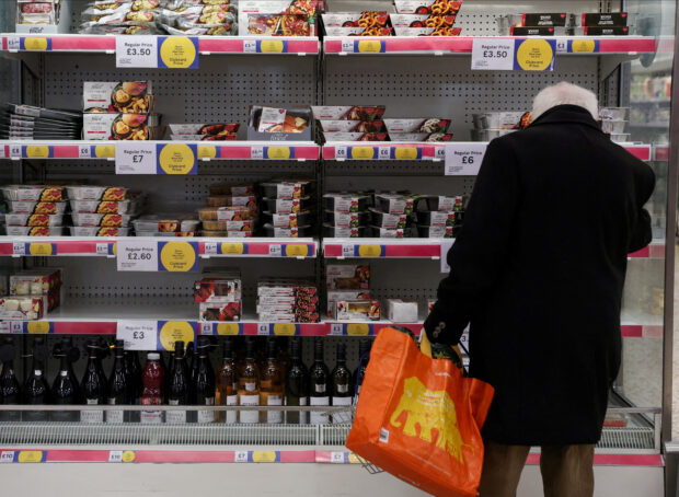 Man shopping in a Tesco Extra supermarket in London