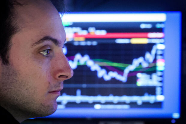 A specialist trader works inside a booth in NYSE
