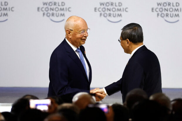 Chinese Premier Li Qiang and Klaus Schwab, founder and executive chair of World Economic Forum