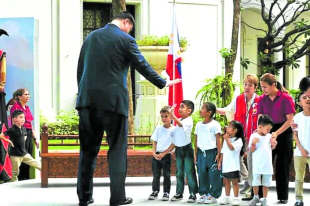 Yao Ming gives a high-five to a kid participant at the Sports Day charity event.