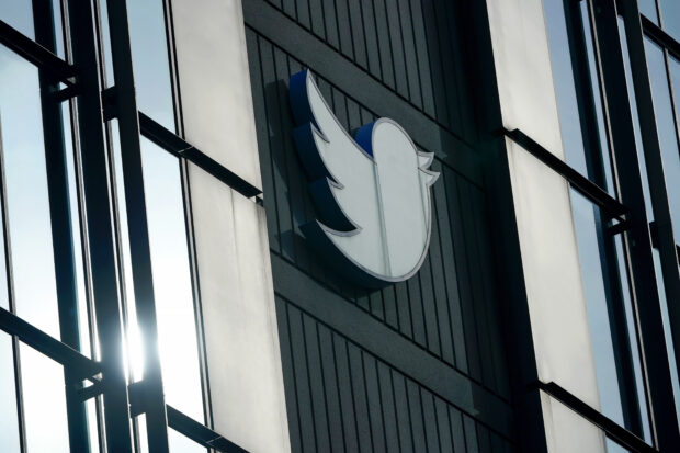 Twitter logo hangs outside company's offices in San Francisco