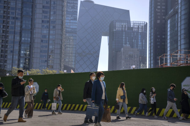 People walk along a path in the central business district of Beijing