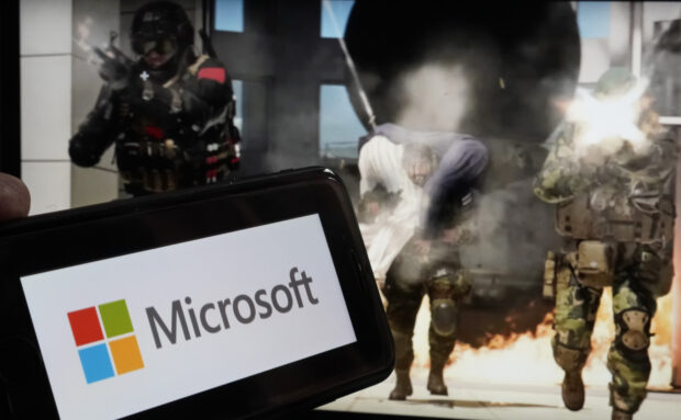 A logo of Microsoft and a scene from Activision "Call of Duty-Modern Warfare"