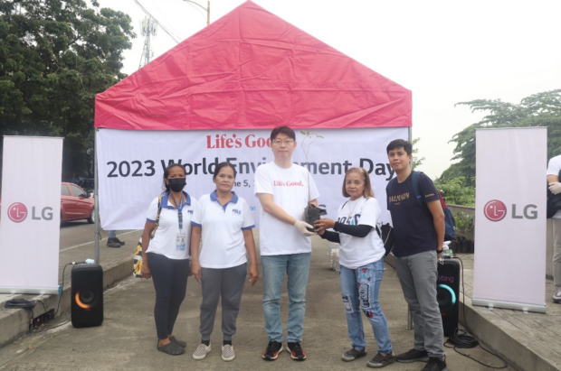 Turnover of plants / Commencement of the Tree Planting ActivityMD with the representatives from The City Environment and Natural Resources Office (CENRO) Ms. Sonia Fuentes Fuentes (the person holding the plant) and Mr. Jimster Samson.