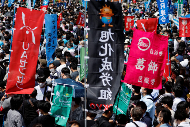 Workers gather at their annual May Day rally to demand higher pay