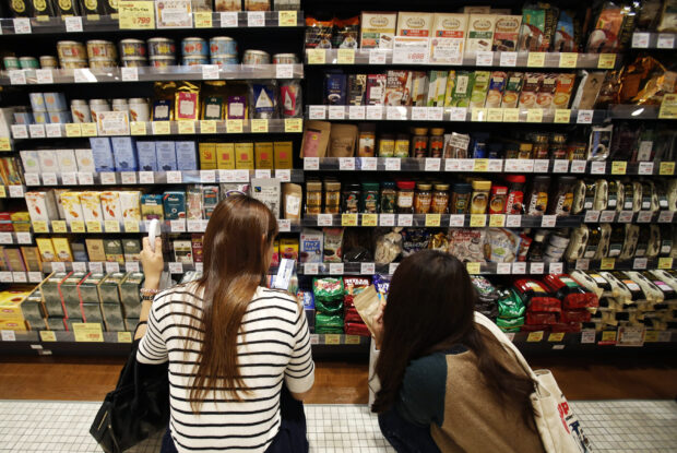 Shopper look at products at luxury food store in Tokyo